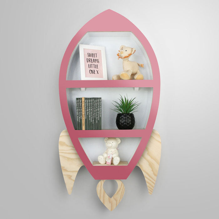 Rocket shaped nursery shelf in pink and wood.