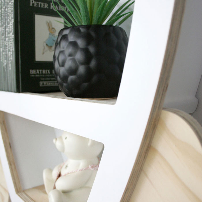 Rocket shaped nursery shelf in white wing attachment detail.