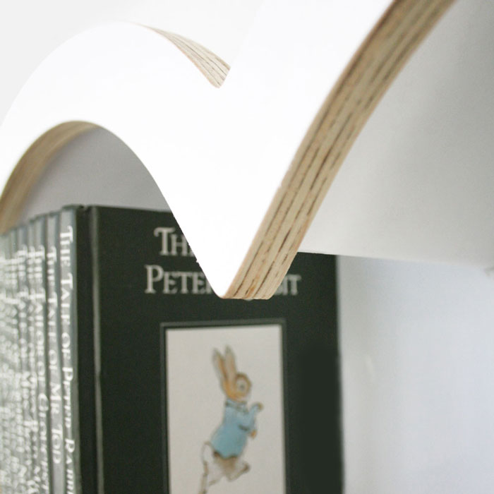 Heart shaped nursery shelf in white arch detail.