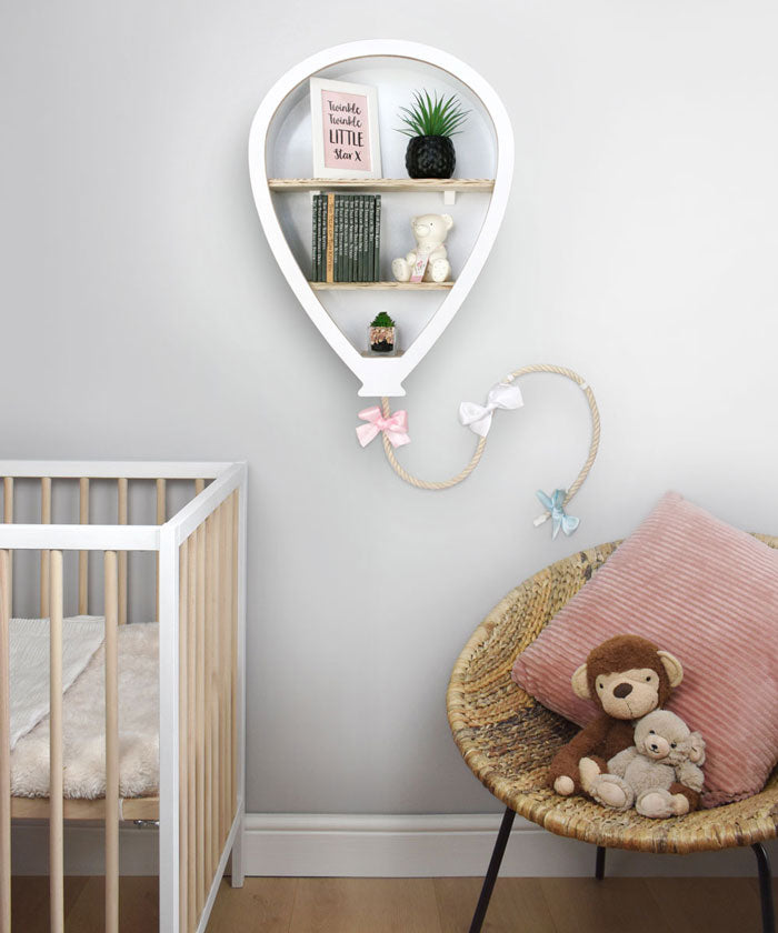 Balloon shaped nursery shelves in white in nursery room setting.