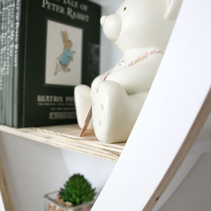 Balloon shaped nursery shelves in white shelf detail.