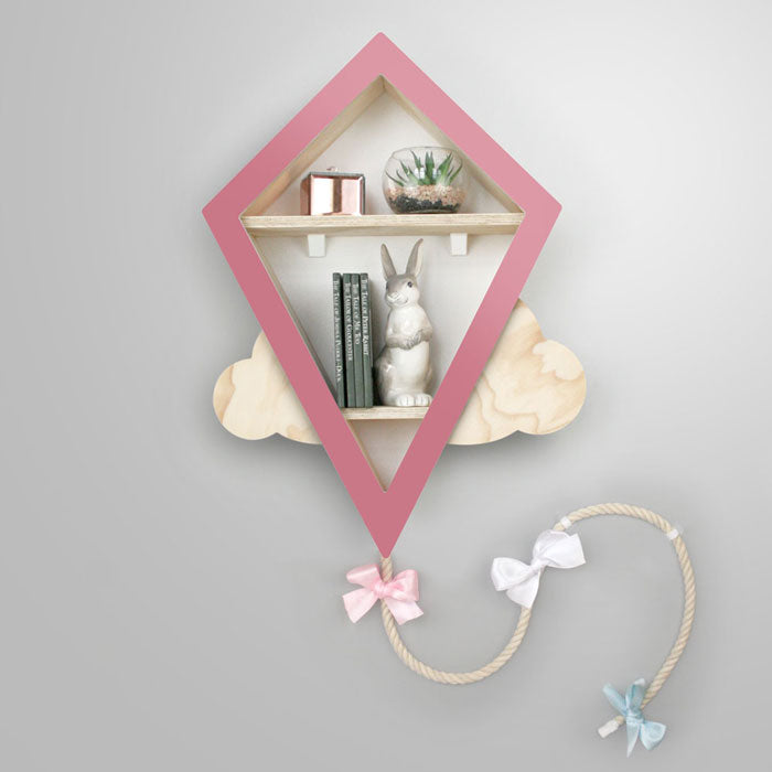 Kite shaped nursery shelf in pink and wood.