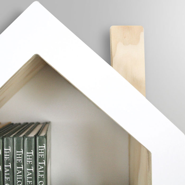 House shaped nursery shelf in white roof detail.