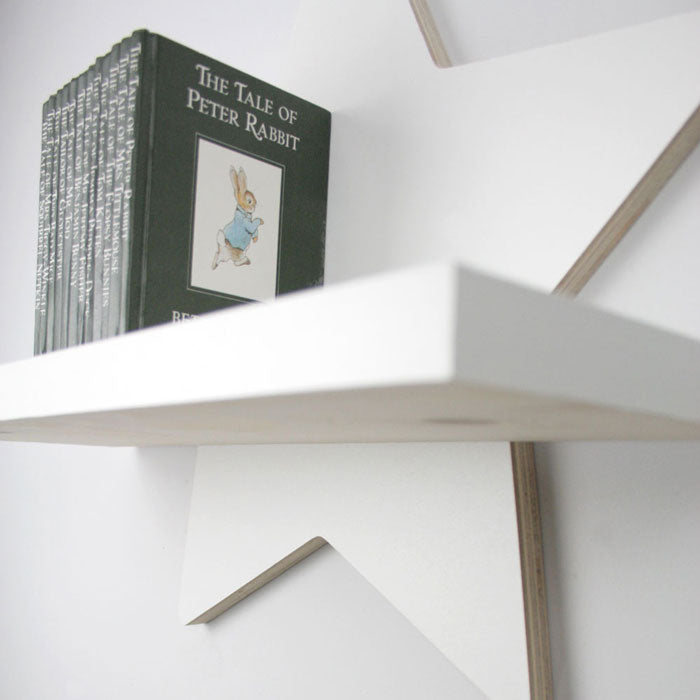 Star shaped nursery shelf in white under shelf detail.