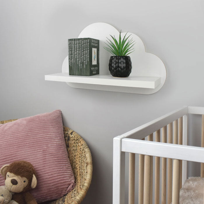 Cloud shaped nursery shelf in white wall mounted in nursery room.