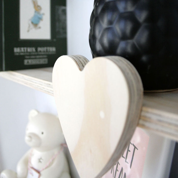 Heart shaped nursery shelf in white heart detail.