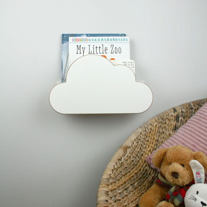 Cloud shaped nursery wall mounted book shelf in white set in nursery.