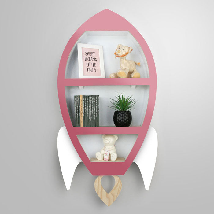 Rocket shaped nursery shelf in pink and white.