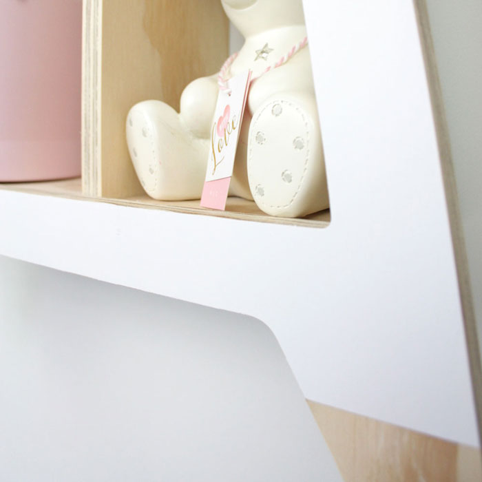 Giraffe shaped nursery shelf in white foot detail.