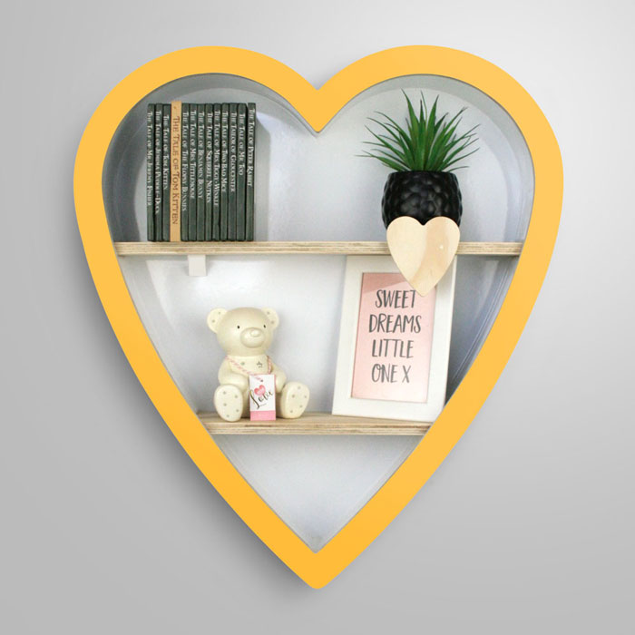 Heart shaped nursery shelf in yellow.