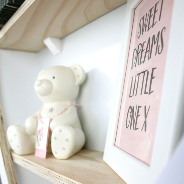 Heart shaped nursery shelf in white shelf detail.