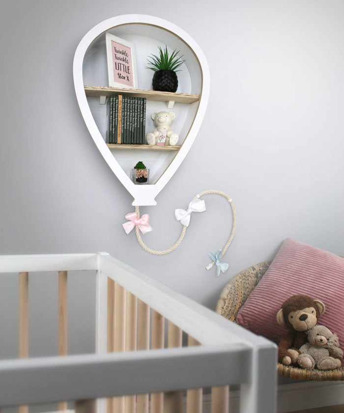 Balloon shaped nursery shelves in white wall mounted in nursery.