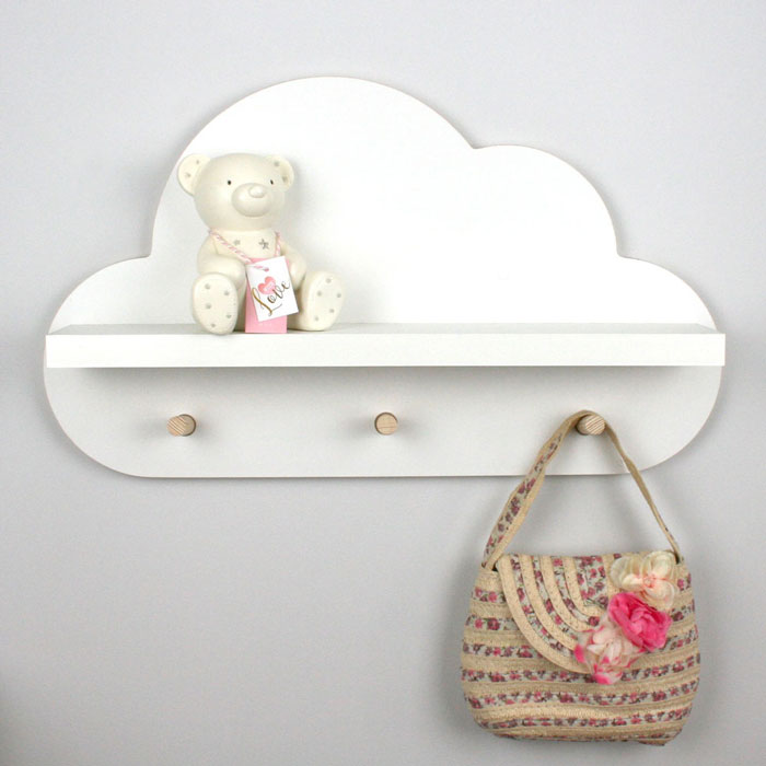 Cloud shaped nursery shelf in white with peg hangers.