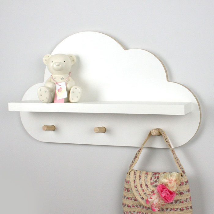 Cloud shaped nursery shelf in white with peg hangers side aspect detail.