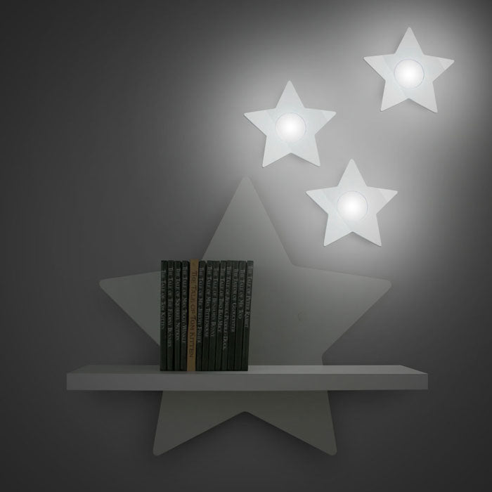 Star shaped nursery shelf in white with illuminated star accessories.